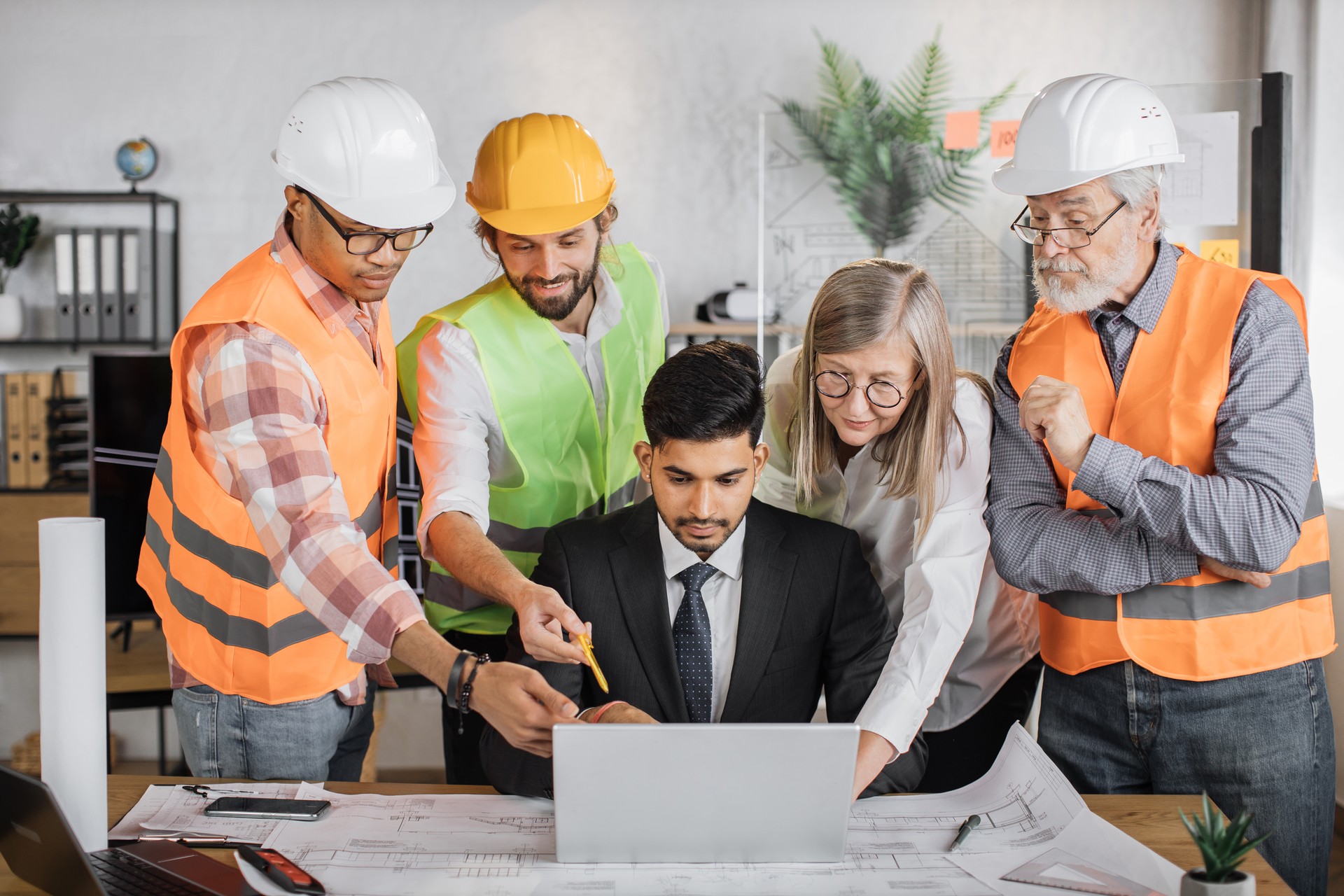 Teams of architects, builders and designers working on project of new modern house.